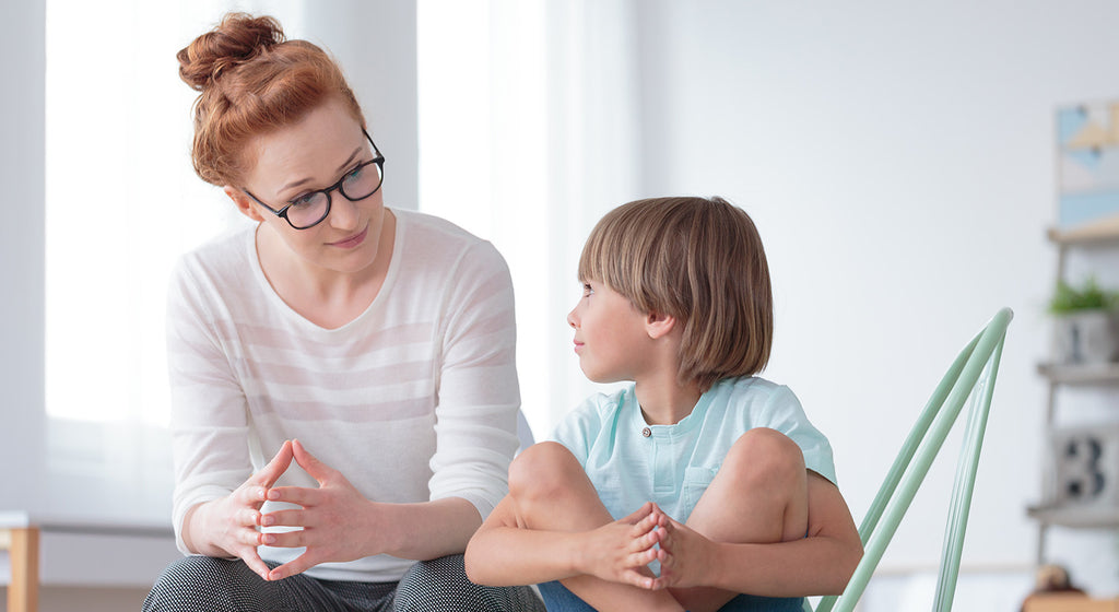 Young mother talking to her child and teaching them effective ways to communicate.